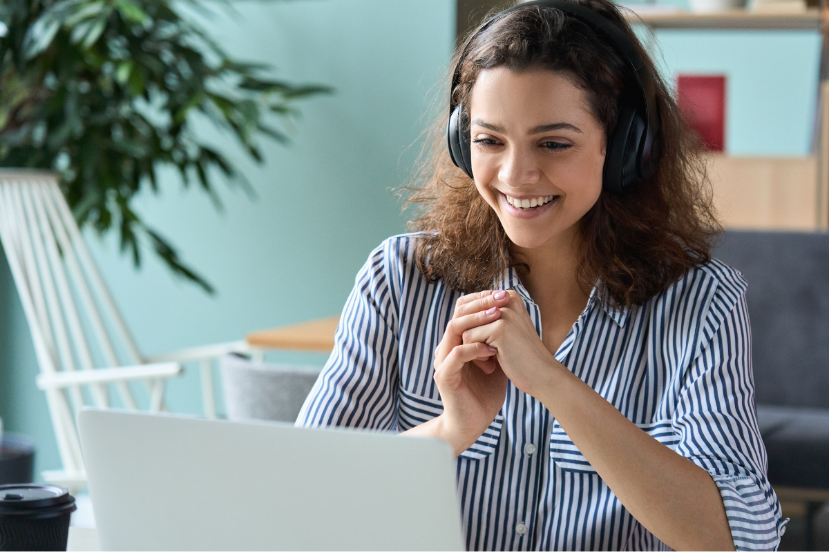 woman on a video call smiling at her computer